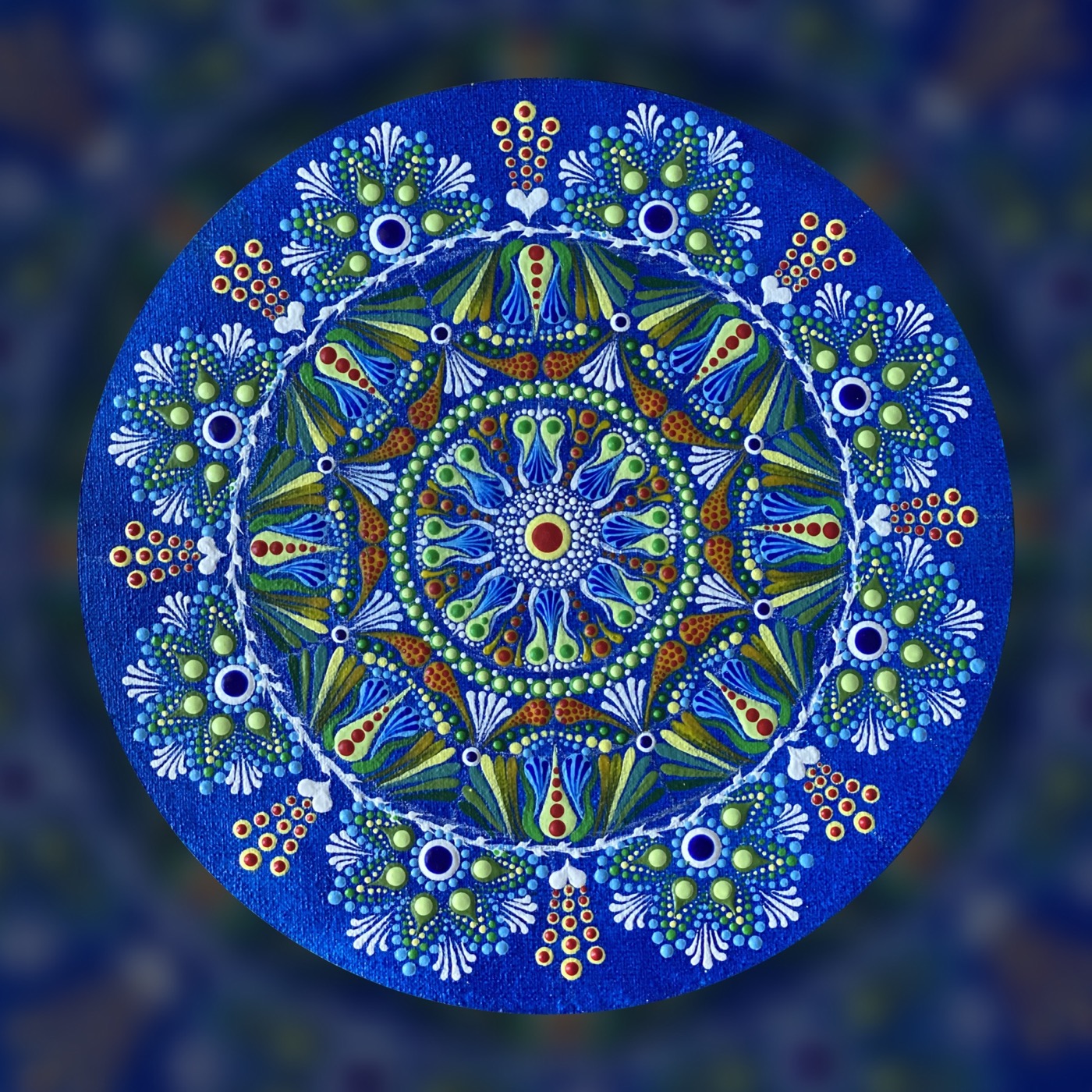A blue circular mandala with botanical details